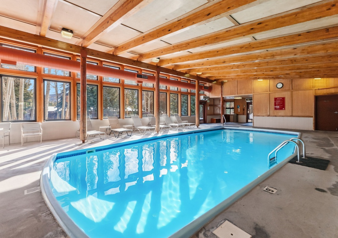 Dive into the indoor oasis with warm wood beams overhead and poolside loungers waiting for your relaxation.