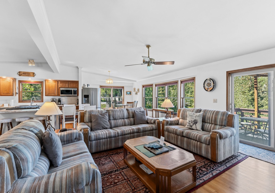 Picture yourself unwinding in this bright, open-concept living space where natural light pours through expansive windows. The comfortable seating invites you to relax while enjoying serene garden views from every angle.