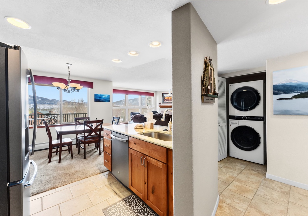 Your open kitchen flows seamlessly into the dining area with mountain views through large windows and convenient in-unit laundry nearby.