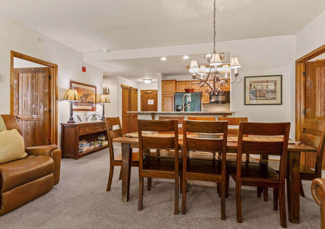 Gather around the large dining table for memorable meals together, with a fully equipped kitchen ready for your culinary adventures and a cozy living space nearby.