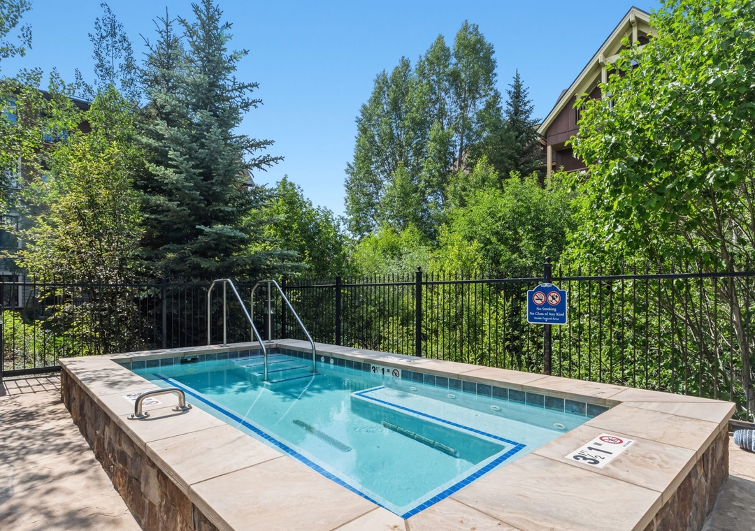 A private hot tub nestled among tall trees and lush greenery offers a serene retreat where you can soak away the day's adventures under open skies.