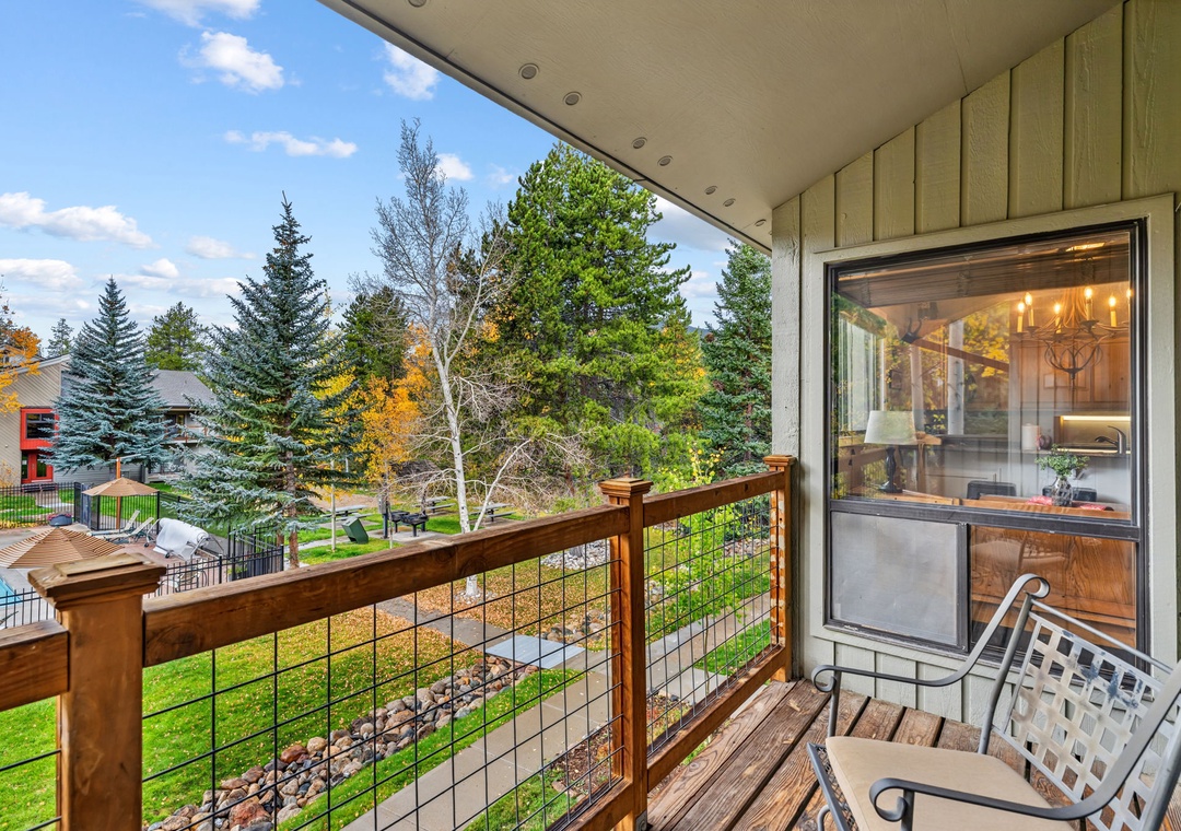 Step onto your private balcony and breathe in the crisp autumn air as you gaze across leafy treetops and peaceful neighborhood views—a perfect spot for your morning coffee.