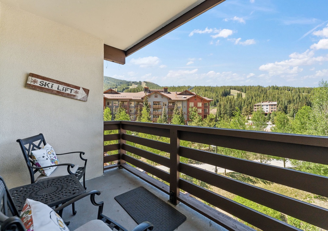 Enjoy your morning coffee on this private balcony overlooking the lush forest and ski village. The fresh mountain air and peaceful setting create the perfect spot to relax and plan your day.