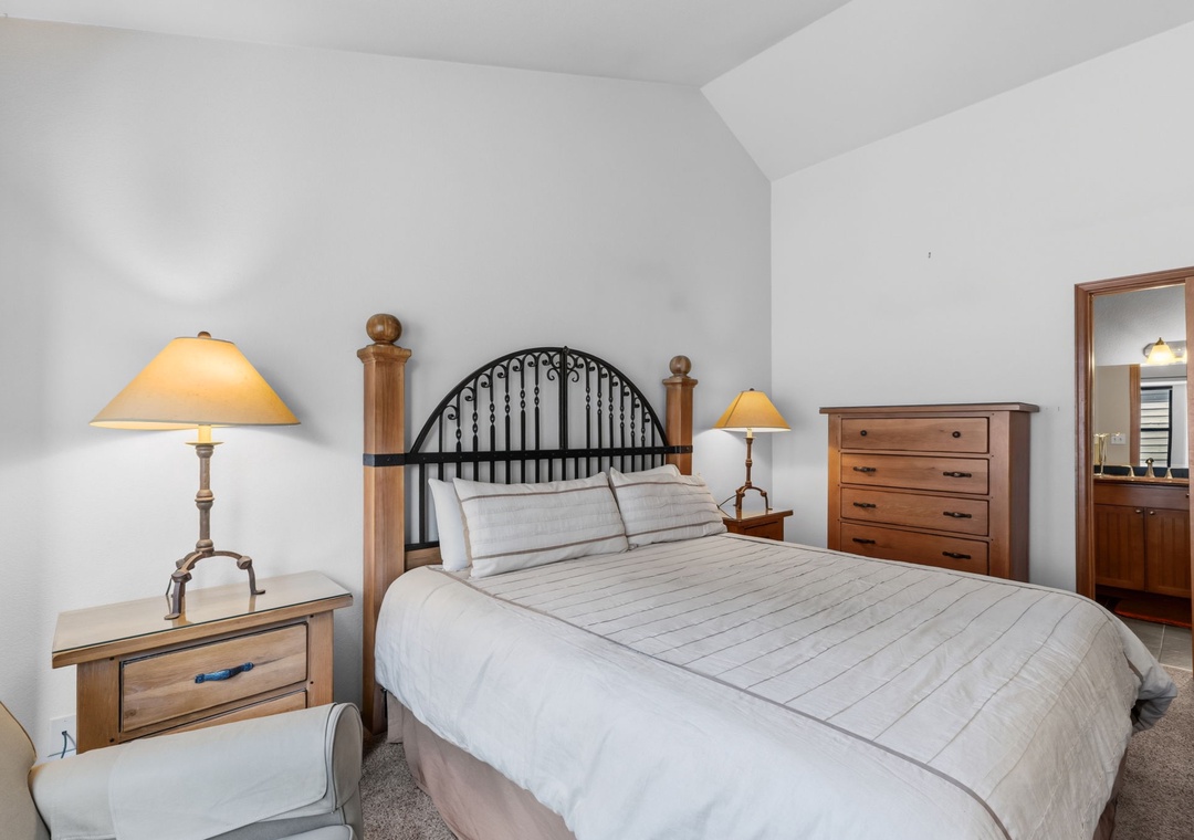 Step into your serene bedroom retreat, where soft lighting and warm wood tones create a peaceful space for restful nights. The plush bed awaits, flanked by matching nightstands and a cozy reading chair.