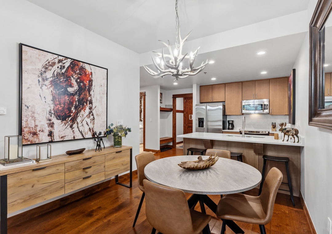 Step into a beautifully designed space where modern elegance meets mountain charm. Your open-concept living and dining area flows seamlessly into a fully equipped kitchen, all bathed in natural light and finished with warm wood accents throughout.