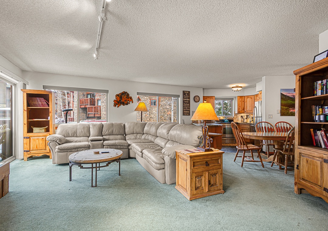 Sink into the plush sectional and unwind in this spacious living area, where natural light and mountain charm create your perfect retreat after a day of adventure.