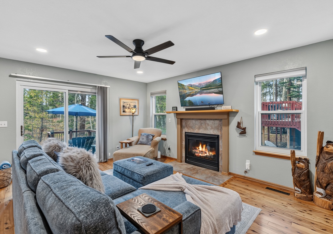 Comfortable main living area with plenty of seating, a gas fireplace, and flat-screen TV