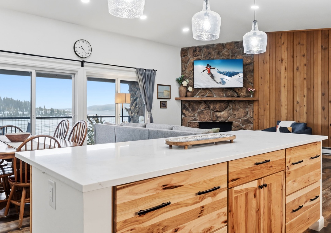 Your spacious kitchen island flows seamlessly into the cozy living room, where you'll gather by the stone fireplace after mountain adventures.