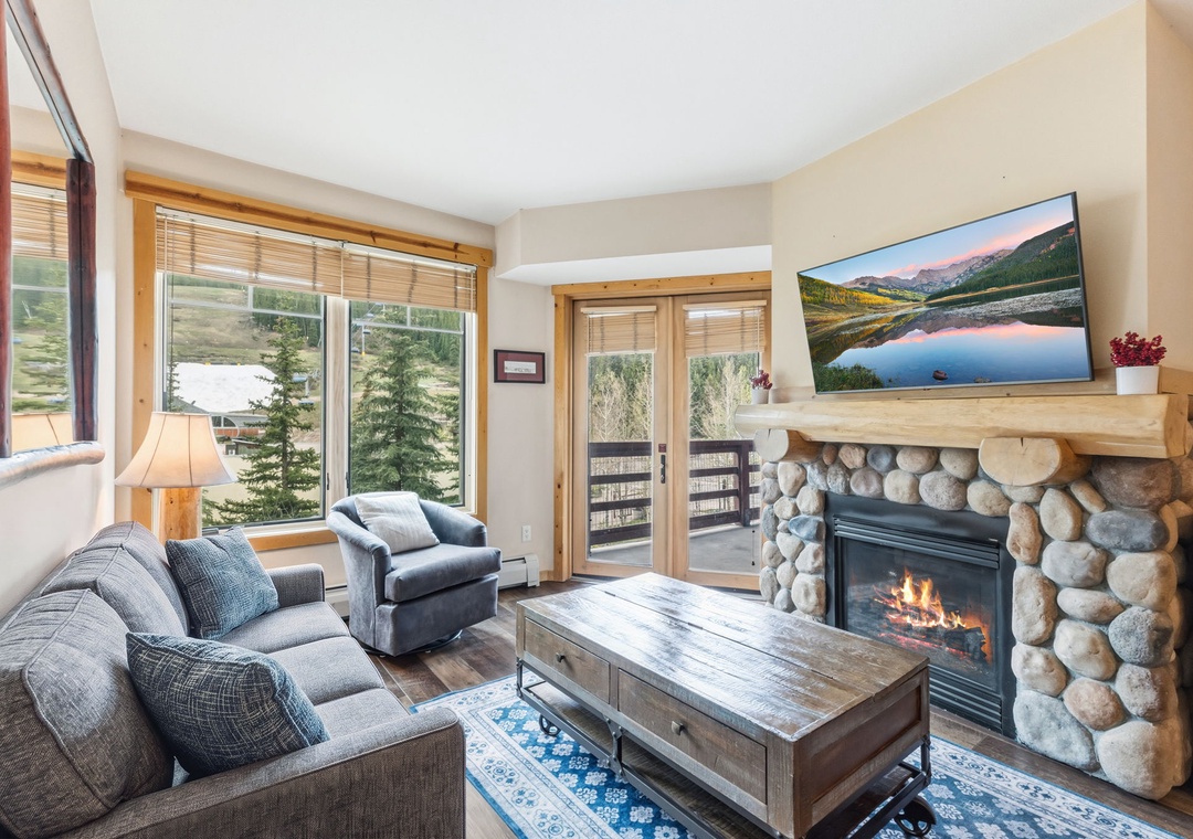 Settle into your mountain retreat where a crackling stone fireplace and stunning natural vistas create the perfect backdrop for your getaway. Floor-to-ceiling windows frame serene landscapes right from your cozy living space.