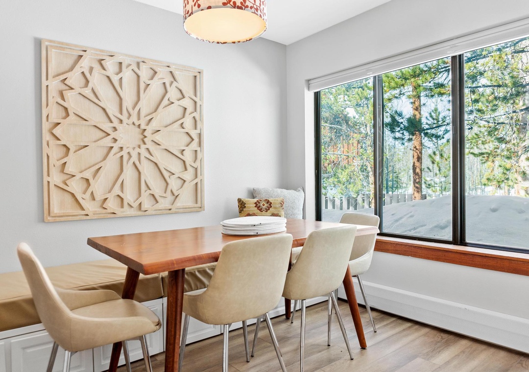 Gather around your private dining table and enjoy meals together, with natural light streaming through large windows that frame peaceful wooded views.