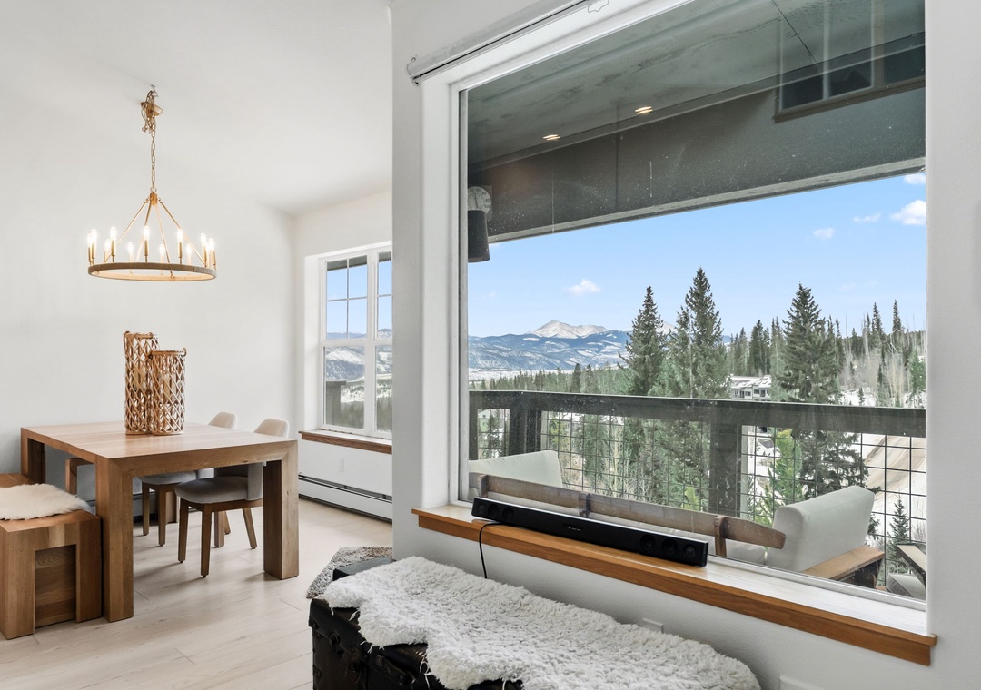 Gather around your beautiful dining table while taking in sweeping mountain views through floor-to-ceiling windows that frame nature's grandeur perfectly.