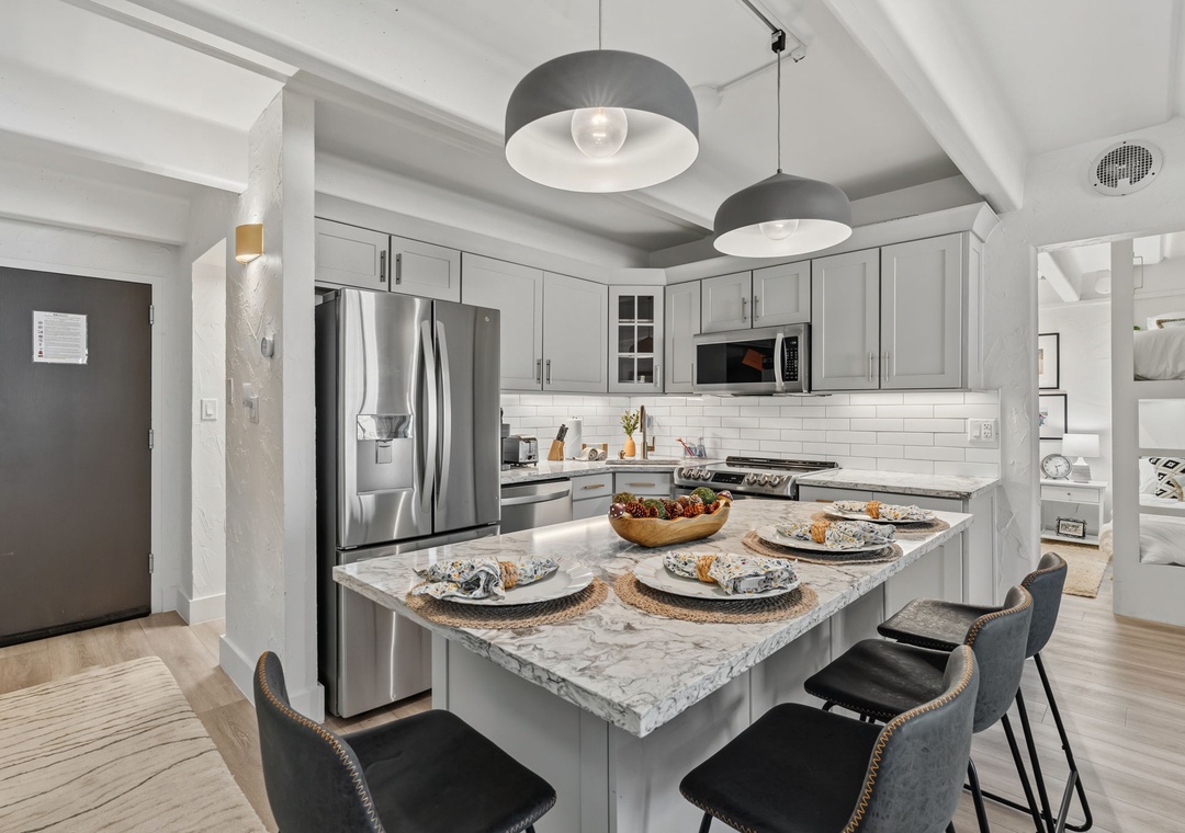 Your fully equipped gourmet kitchen a stunning island where you can gather for meals or morning coffee.