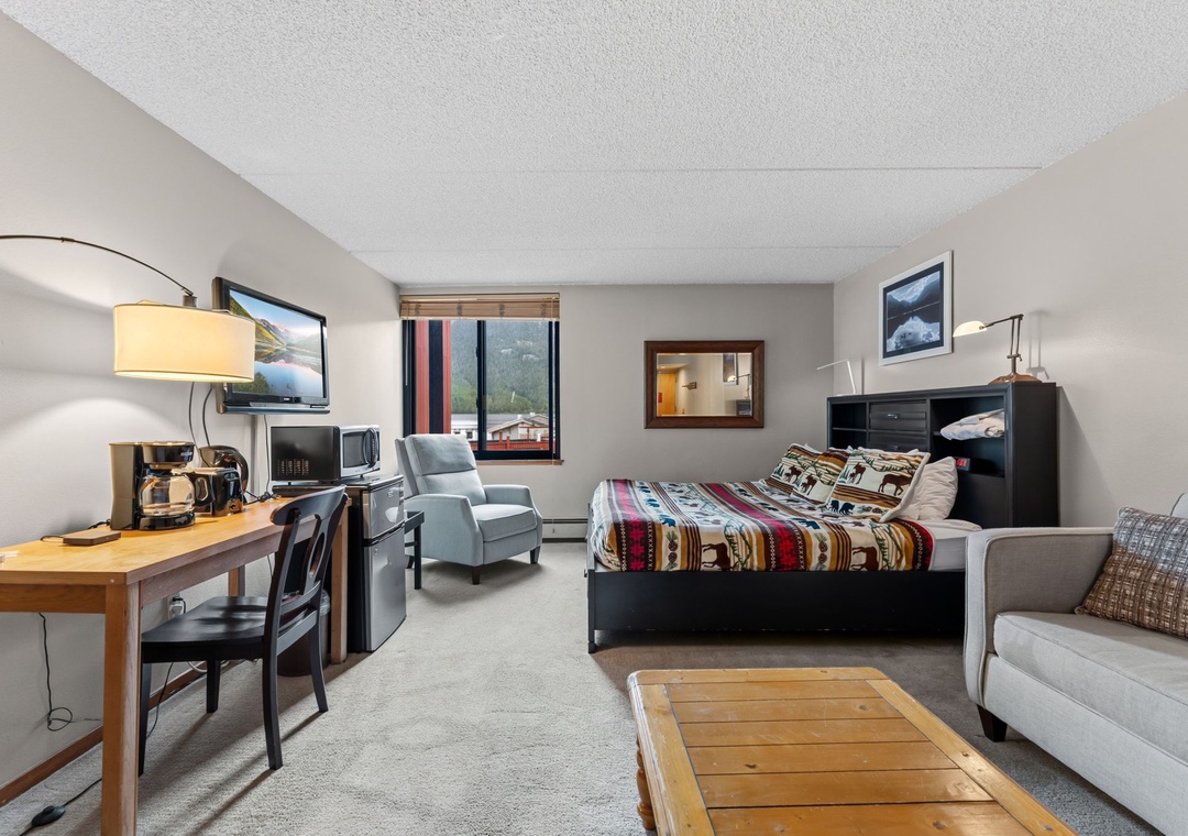 Relax in your cozy studio with a comfortable bed, seating area, and kitchenette—perfect for unwinding after a day of mountain adventures. Enjoy scenic views right from your window.