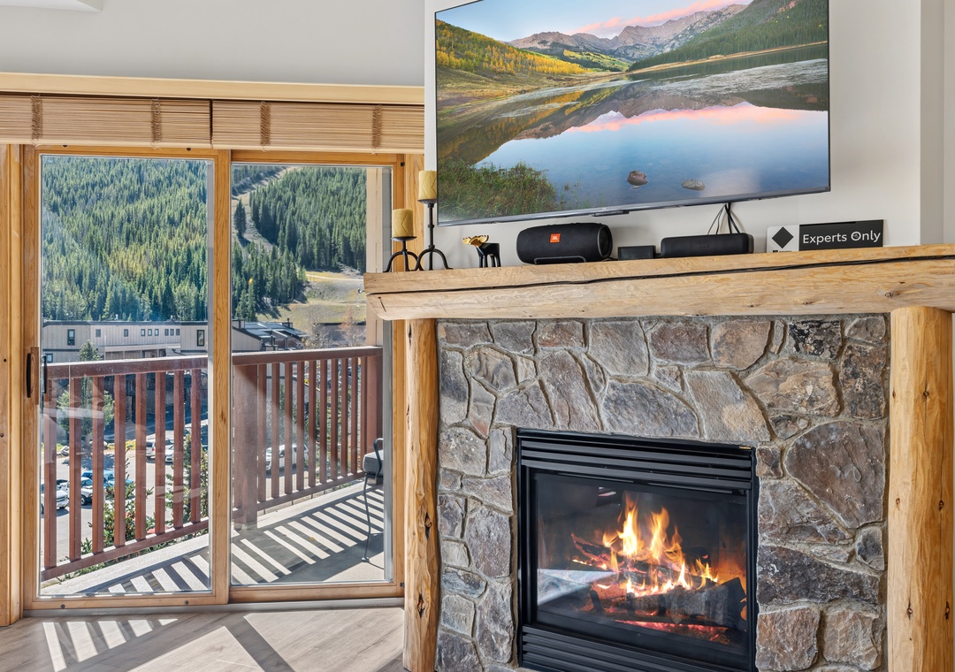 Cozy up by the stone fireplace beneath your favorite shows, or step onto your private balcony and take in views of lush evergreen forests and mountain peaks beyond.