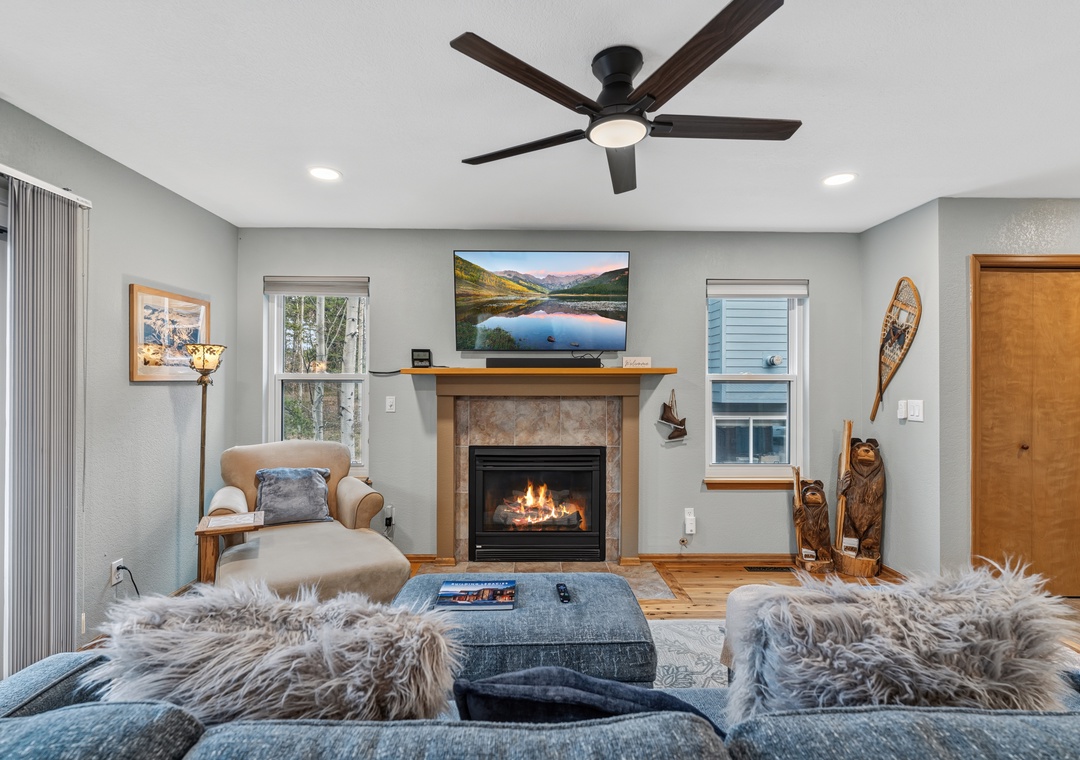 Inviting living room, with plush seating, a gas fireplace, and rustic mountain touches create the perfect spot to unwind after exploring.