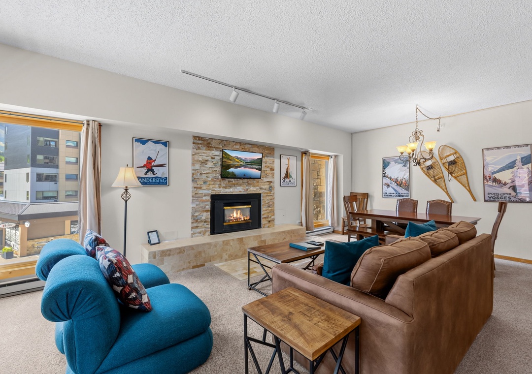 Settle into your cozy living room with plush seating, a warm fireplace, and rustic mountain charm inviting you to unwind after a day of adventure.