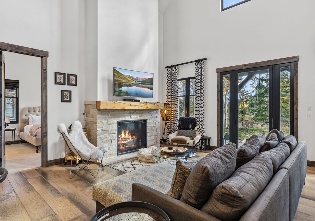 Sink into plush comfort by the fireplace, where natural light streams through the windows .