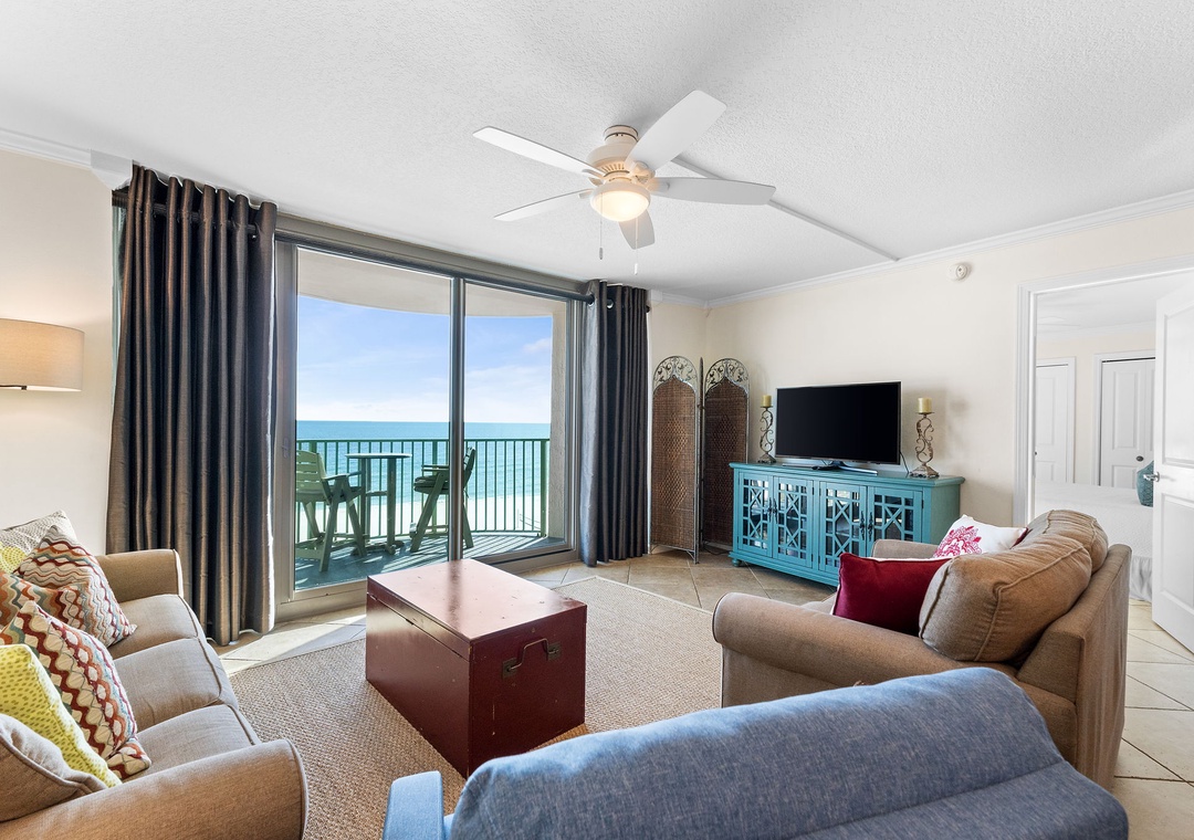 Relax in your spacious living room with stunning beach views through floor-to-ceiling windows