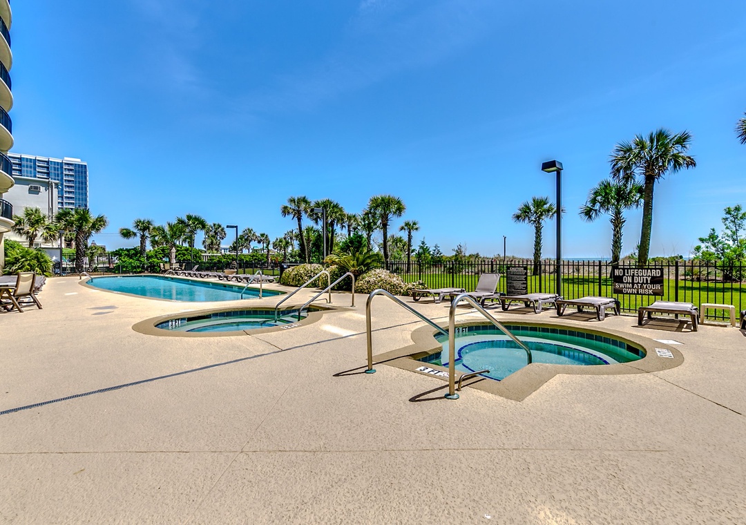 Dive into your own tropical paradise! Soak up the sun by the sparkling pool or unwind in the bubbling hot tub, surrounded by swaying palm trees and blue skies.