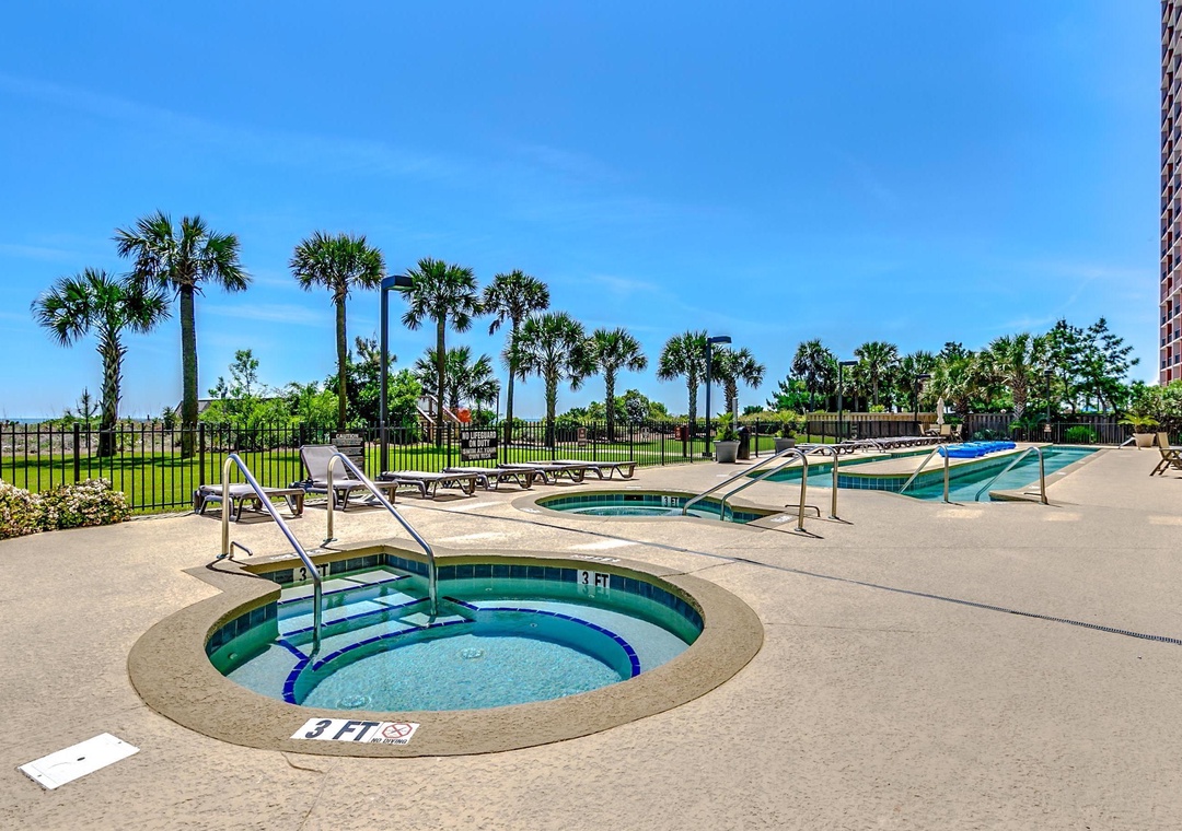 Step into your own tropical paradise! Soak up the sunshine by the sparkling pool and hot tub, surrounded by swaying palm trees and endless blue skies. Perfect for unwinding after your adventures.
