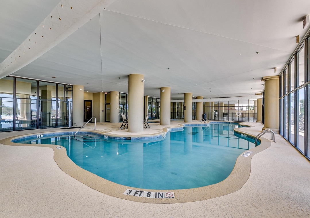 Dive into relaxation in your private indoor pool sanctuary, where floor-to-ceiling windows flood the space with natural light and create a serene aquatic retreat perfect for year-round swimming.