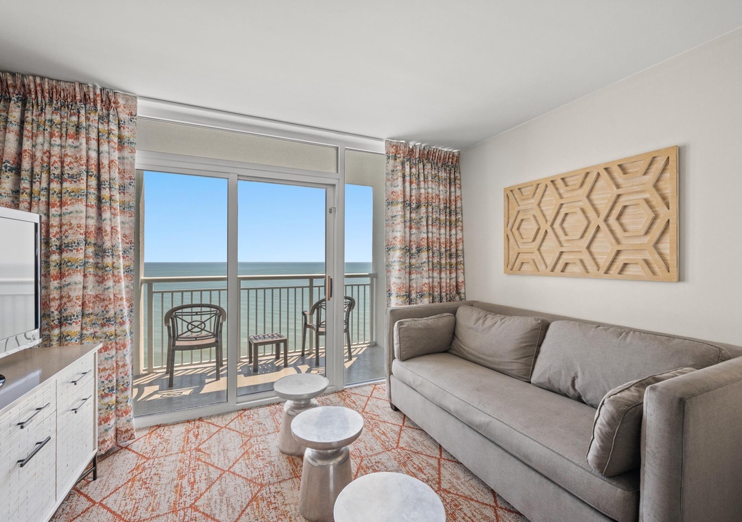 Bright living area with comfy seating—ideal for movie nights, board games, and relaxing after the beach.