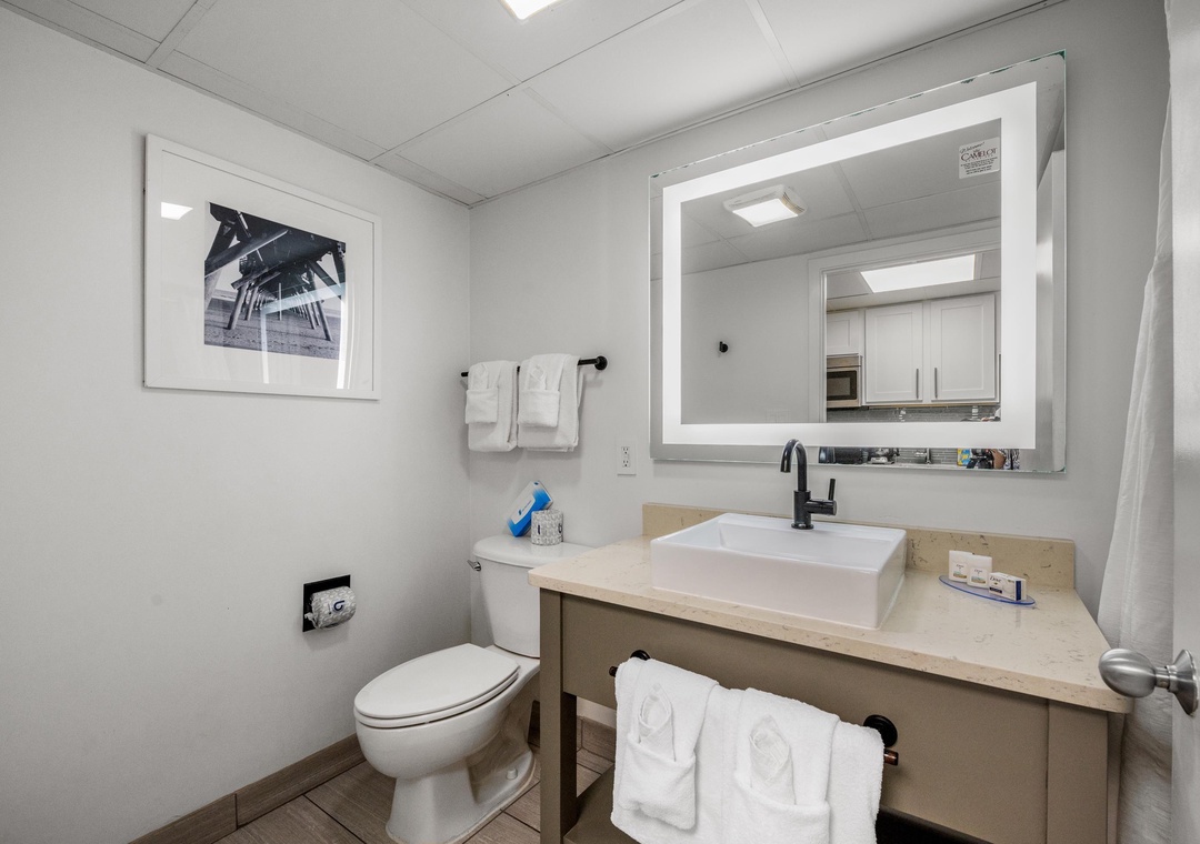 Clean, bright bathroom with plenty of space to get ready after a beach day.
