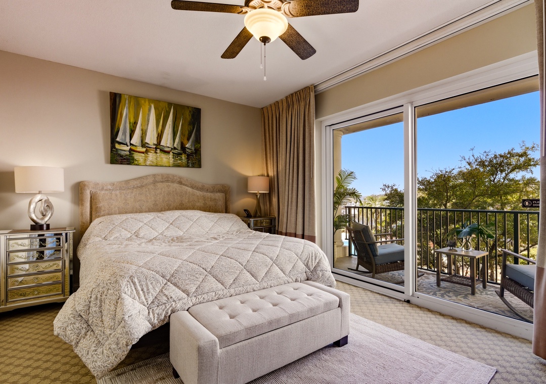 Primary bedroom with king bed and balcony