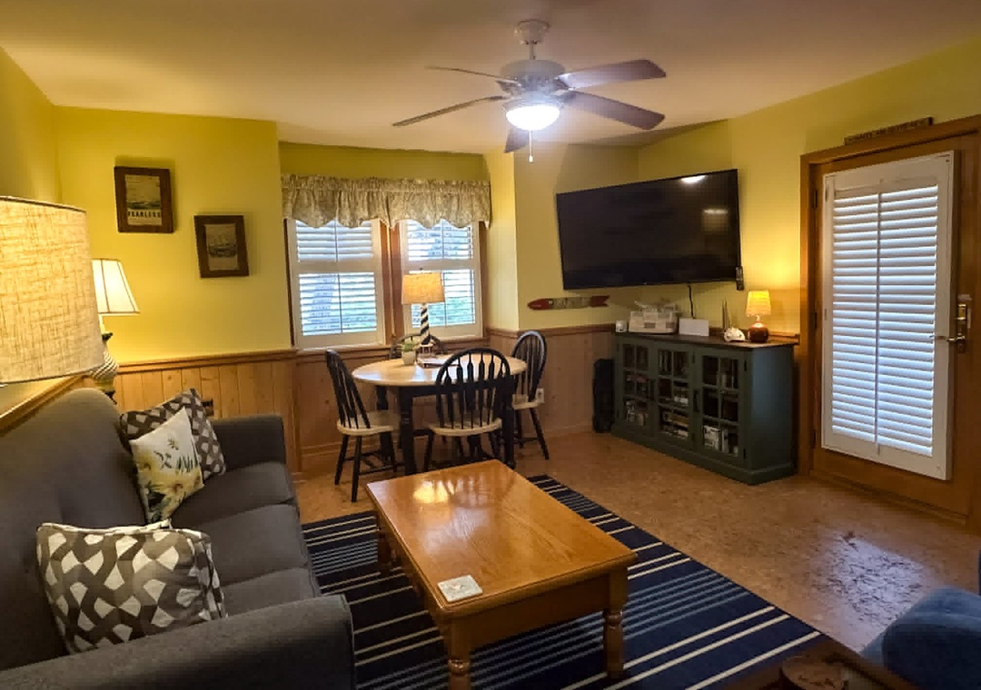 Living Area with TV and Screened Porch Access