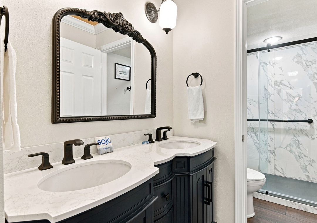 Primary ensuite bathroom with dual vanities