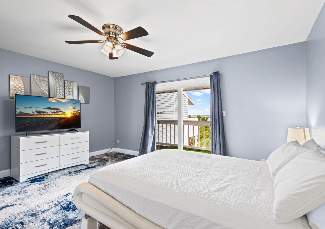 Primary bedroom with balcony access