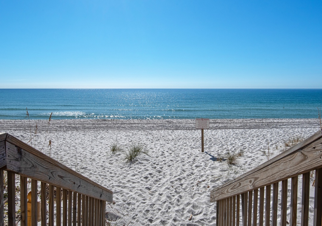 Step out onto the white sand beach