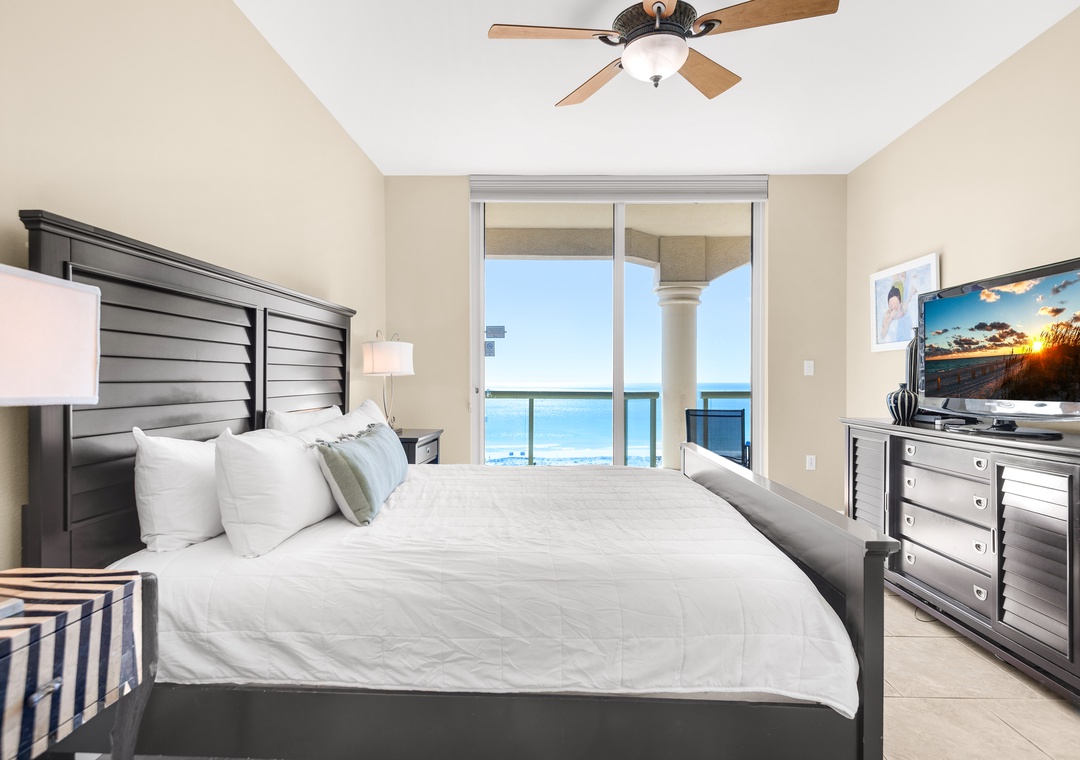 The king primary bedroom features floor-to-ceiling windows and balcony access
