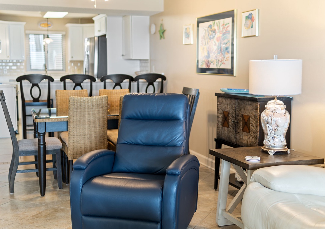 Sandy Key 628- Settle into your inviting living space, where comfort meets coastal charm. Sink into the plush leather recliner or gather around the dining table after exploring the beach.