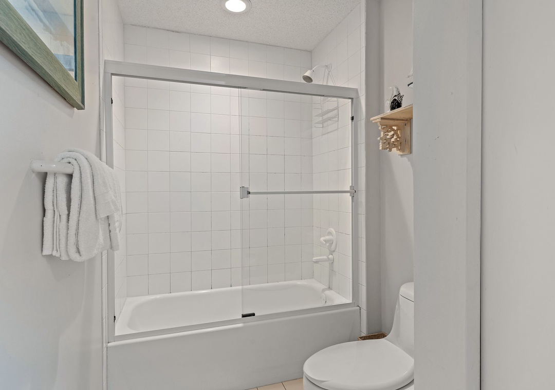 Beach Colony T15B- Freshen up in your bright, spotless bathroom with a convenient tub-shower combo and clean white tile throughout. Soft towels await to wrap you in comfort after a relaxing soak.