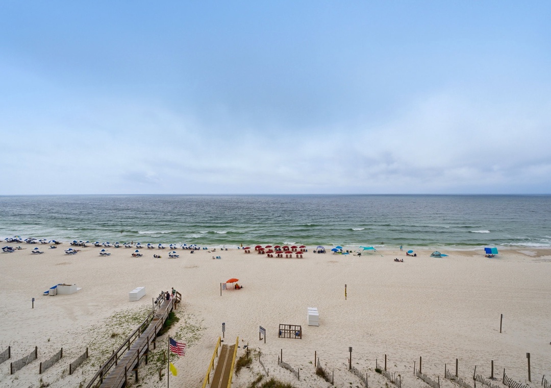 Ocean Breeze E601- A pristine stretch of coastline awaits, where gentle waves meet soft sand and colorful umbrellas dot the shore, offering the perfect beachside escape.