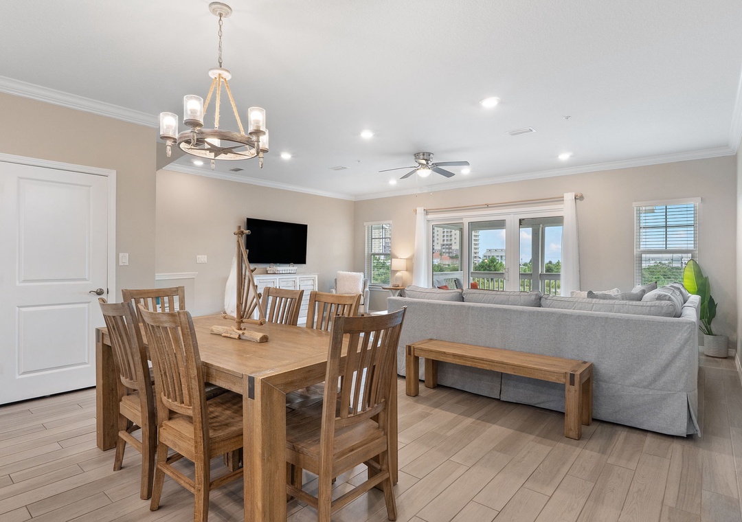 Saltwater & Sunsets- Gather around the dining table or unwind on the sofa—this inviting space opens to bright windows and greenery, perfect for relaxing together after a day of adventure.