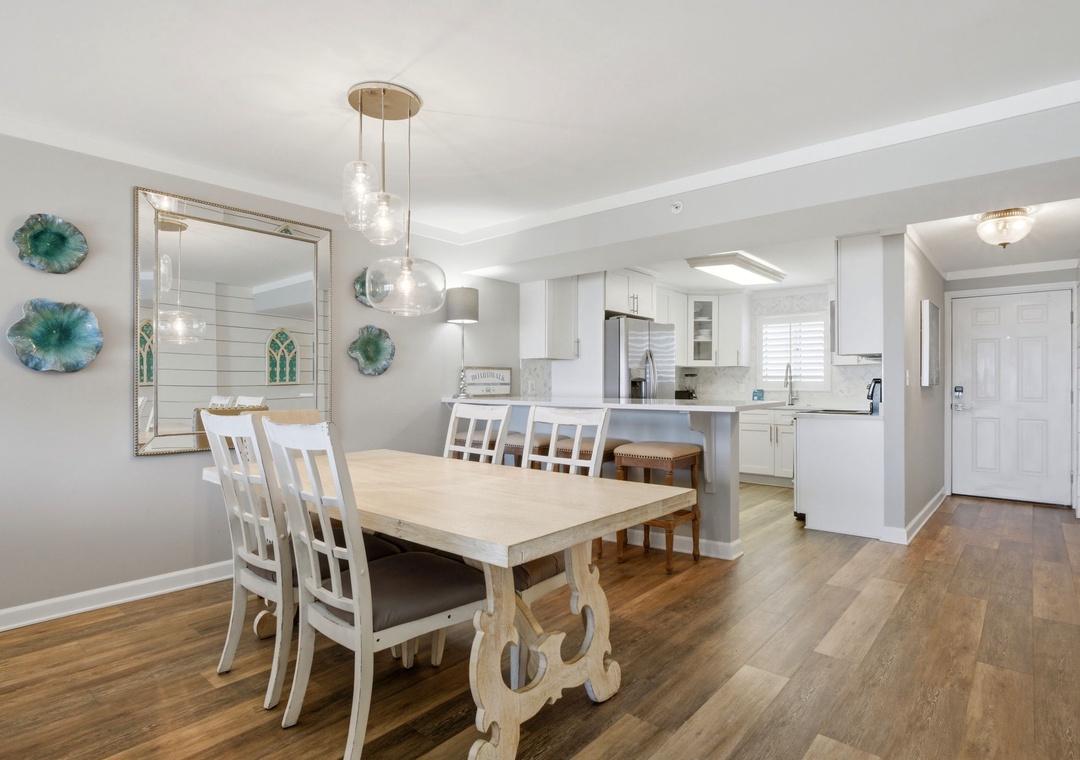 Sandy Key 827- Gather for meals at a charming farmhouse table under warm pendant lighting. The open layout flows seamlessly into your fully equipped kitchen, perfect for cooking and connecting.