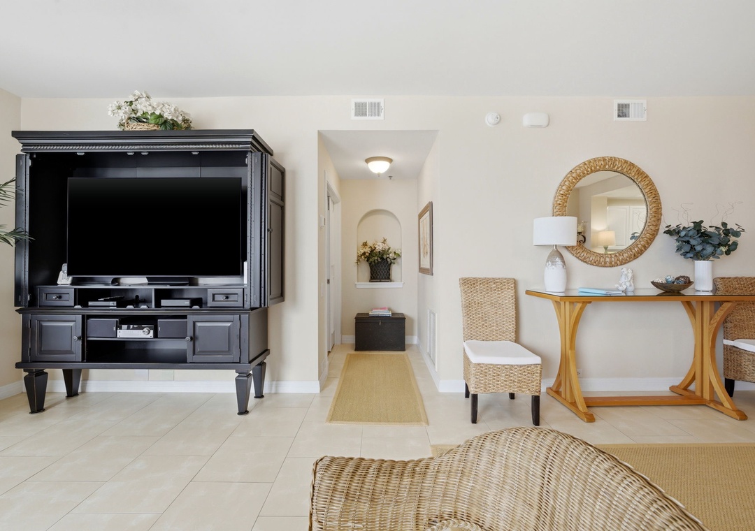 Beach Colony Tower PH1B - Unwind in your bright, airy living space with coastal-inspired wicker seating, elegant furnishings, and a large flat-screen TV for your entertainment. Your home away from home awaits.