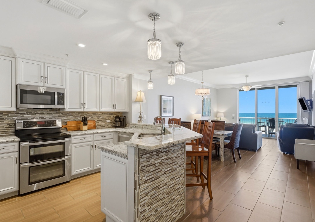 This open-concept space blends your vacation kitchen, dining, and living areas with stunning ocean views. Cook gourmet meals with modern appliances, share stories around the island, and unwind in style.