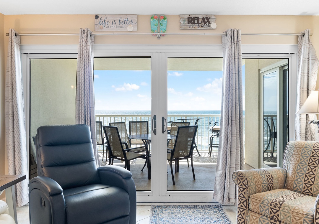 Sandy Key 628- Step into your living space where floor-to-ceiling doors open to reveal stunning ocean views and your private balcony. Relax in the comfort of plush recliners while soaking in the coastal breeze and endless blue horizon just beyond.