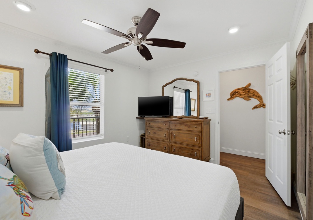 Grand Caribbean 305W- Drift off to sleep in this cozy bedroom with crisp linens and a ceiling fan to keep you comfortable. Natural light fills the space, while coastal touches add charm to your retreat.