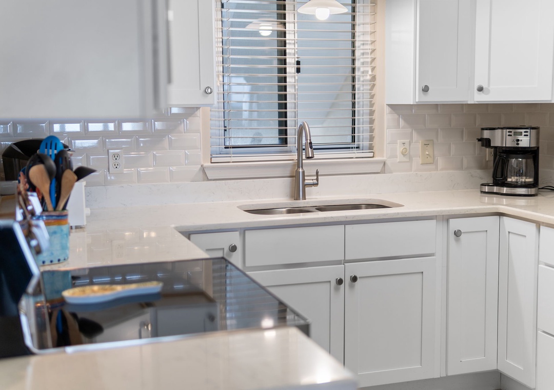 Sandy Key 628- Step into this bright, fully-equipped kitchen where you'll find gleaming countertops, modern appliances, and everything you need to prepare your favorite meals during your stay.
