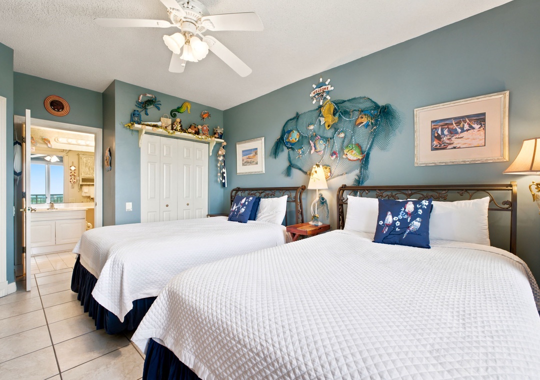 Beach Colony W13A- Drift off in this nautical-themed bedroom with two plush beds, coastal decor, and crisp linens that invite restful sleep after your beachside adventures.