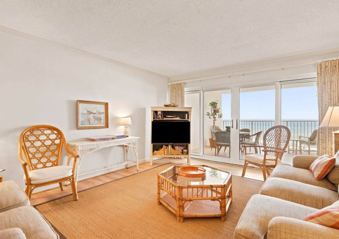 Sandy Key 338- Step into your sun-filled living room where plush coastal seating invites you to relax, and those glass doors open to reveal your private balcony overlooking endless ocean views.