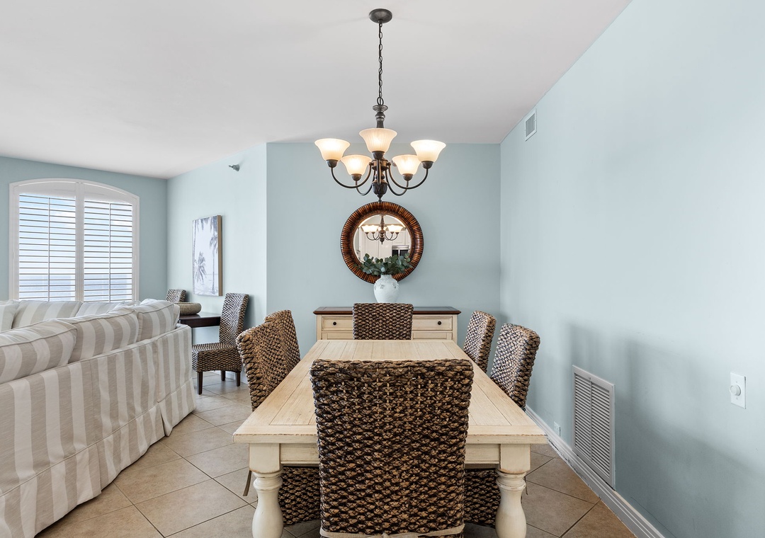 Beach Colony Tower 10C- Gather around the handsome farmhouse-style dining table with woven seating, where coastal hues and natural light create the perfect backdrop for your vacation meals together.