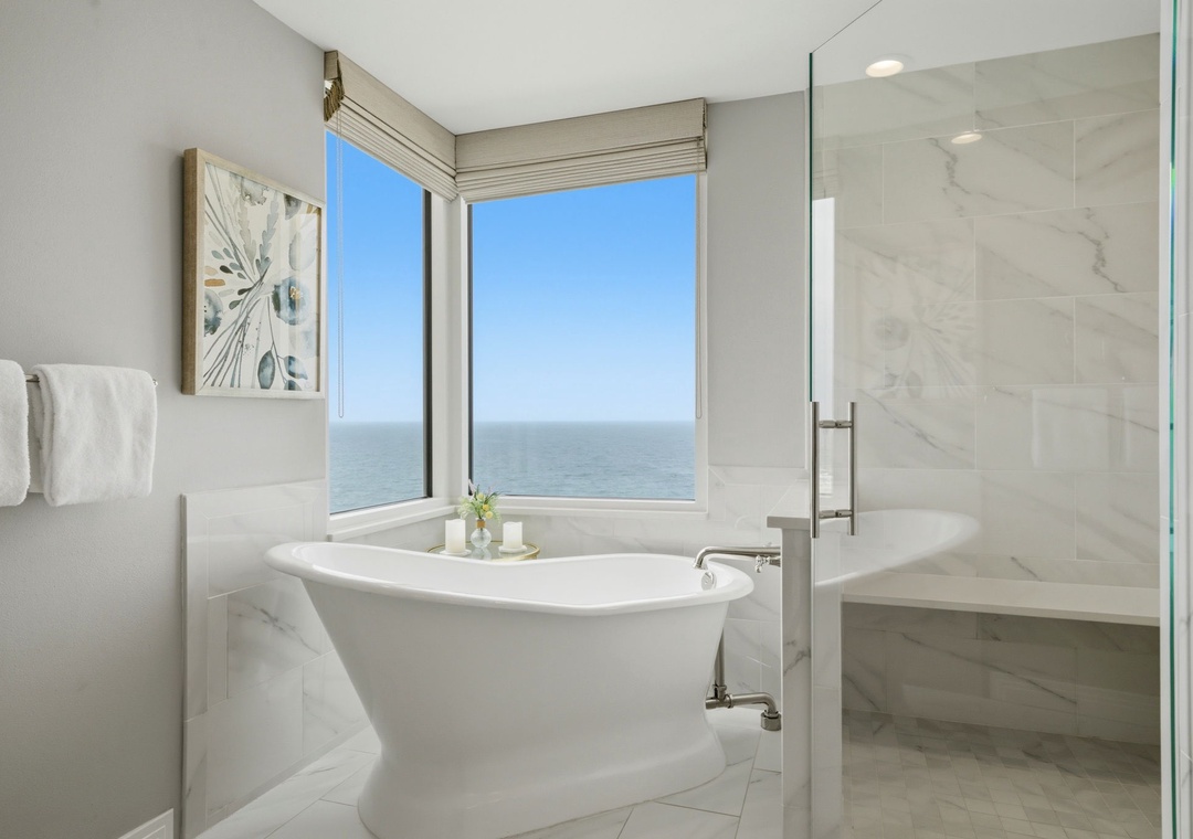 Beach Colony Tower PH1B - Unwind in the elegant marble bathroom with a luxurious soaking tub and walk-in shower, framed by breathtaking sea views. Fresh towels and soothing details welcome you after a long day.