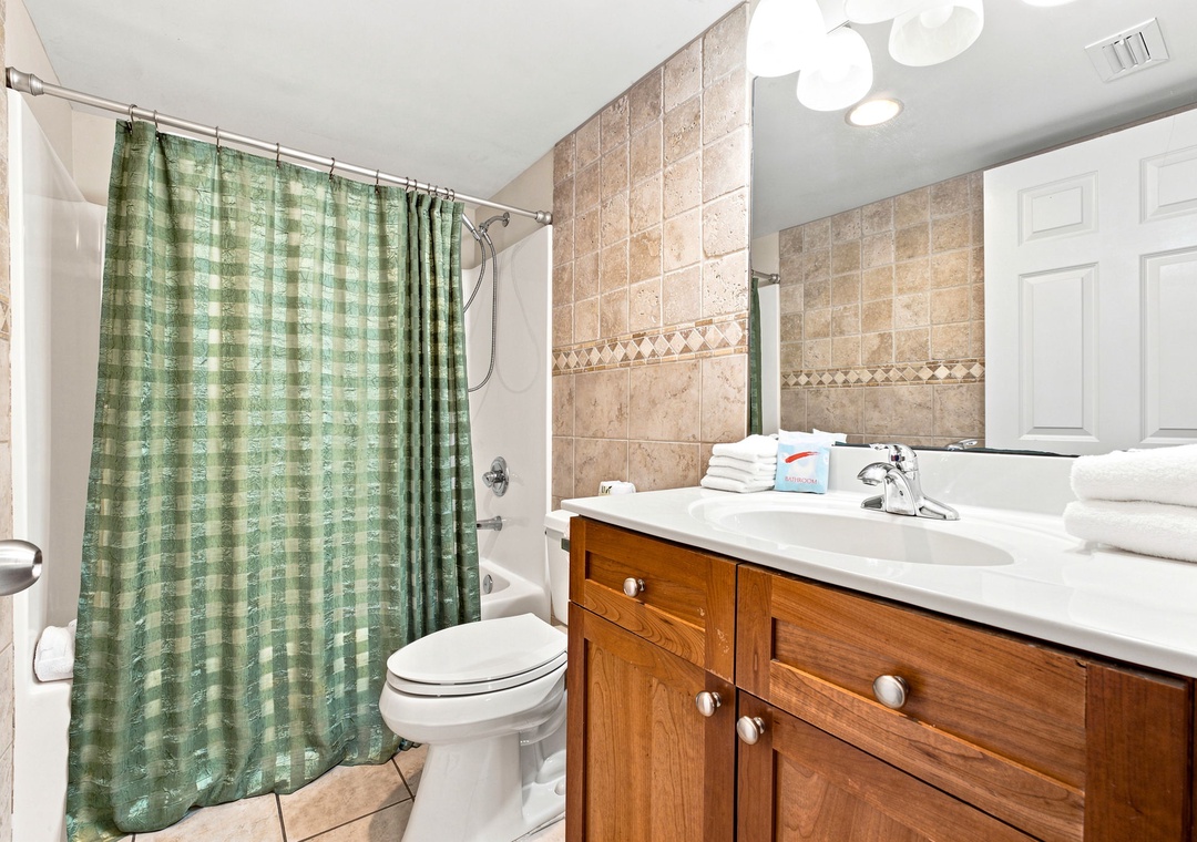 Ocean Breeze W 105- Step into your beautifully tiled bathroom with warm neutral tones and a wood vanity. Fresh towels await, and the spa-like feel invites you to unwind after a day of adventure.