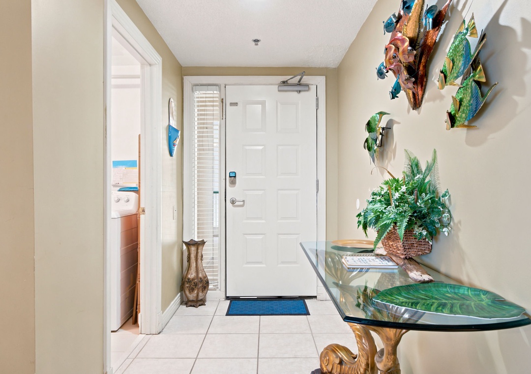 Beach Colony W13A- Step into your tropical oasis! Bright, beach-inspired art and lush greenery welcome you home, setting the tone for a relaxing coastal getaway.