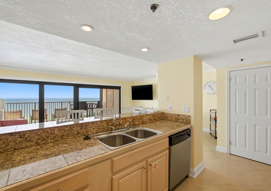 Ocean Breeze E601- Your kitchenette features granite counters and stainless steel appliances, with stunning ocean views through the sliding glass doors leading to your balcony.
